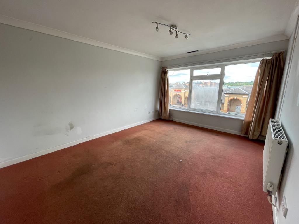 Lot: 21 - TWO-BEDROOM FIRST FLOOR MAISONETTE FOR REPAIR AND IMPROVEMENT - Living room with windows to the front
